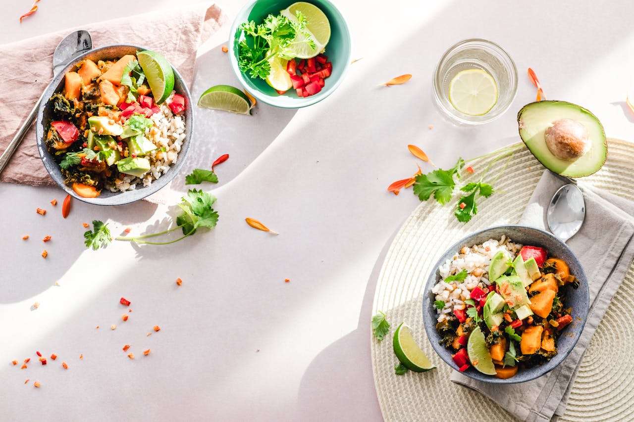 home-hero-1 Top-down view of vibrant vegan bowls filled with fresh vegetables, perfect for a healthy meal.